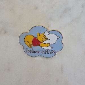Disney Store Winnie the Pooh 'I Believe in Naps' enamel pin.
